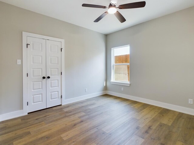 unfurnished room with ceiling fan and light wood-type flooring