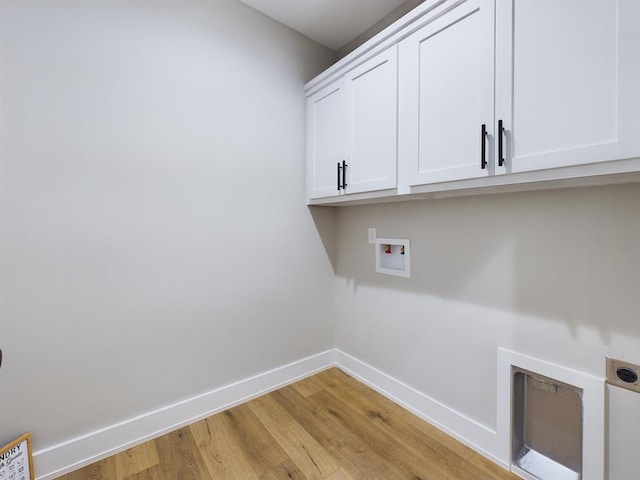 laundry area featuring cabinets, washer hookup, hookup for an electric dryer, and light wood-type flooring