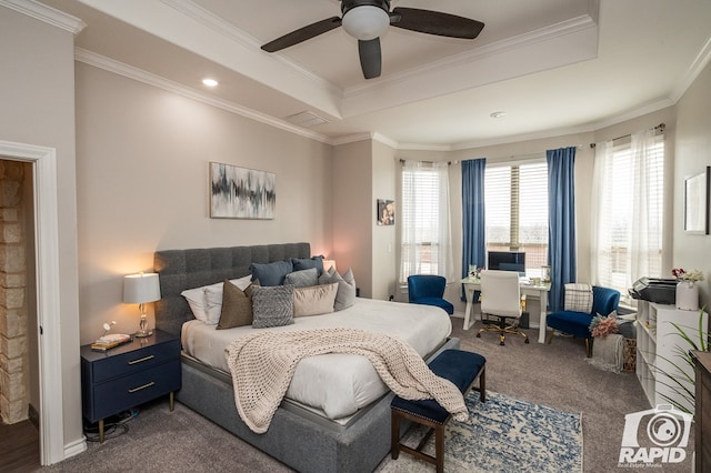 bedroom featuring crown molding, ceiling fan, dark carpet, and a raised ceiling