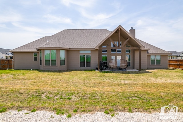back of house with a chimney, fence, a patio, and a lawn