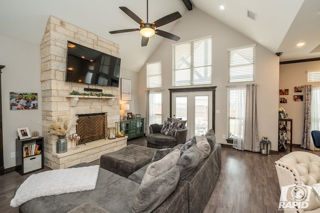 living room with dark wood-type flooring, high vaulted ceiling, ceiling fan, and visible vents