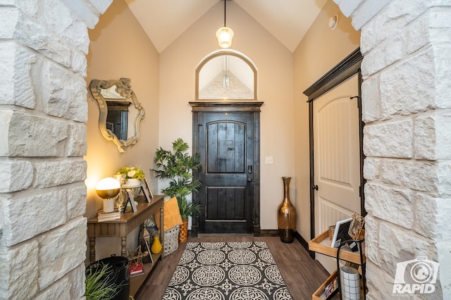 entryway featuring high vaulted ceiling and wood finished floors