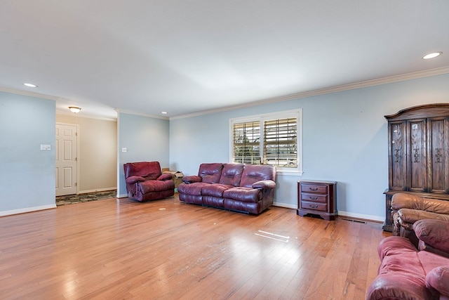 living room featuring ornamental molding and light hardwood / wood-style floors