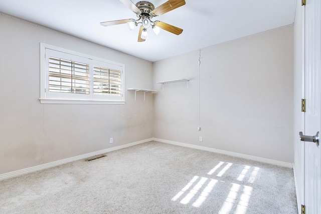 spare room featuring ceiling fan and light colored carpet