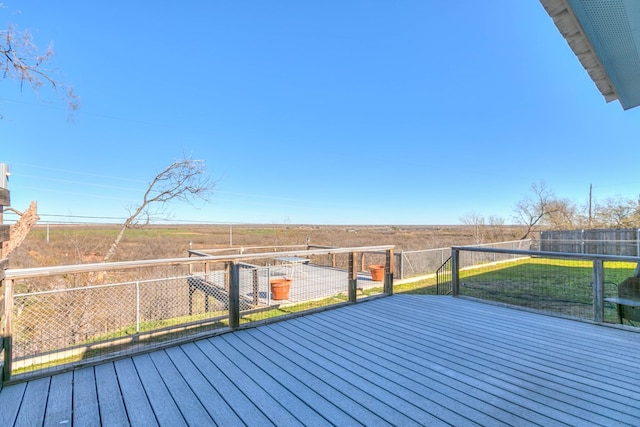 wooden terrace featuring a rural view