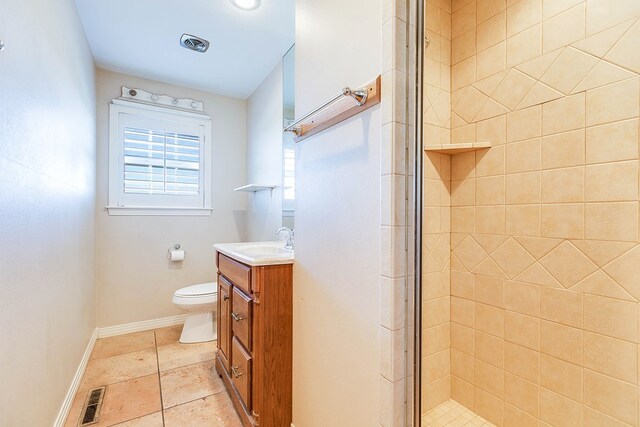 bathroom featuring vanity, toilet, and a shower with shower door