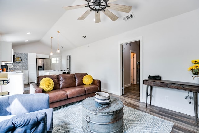 living room featuring vaulted ceiling, dark wood-type flooring, and ceiling fan