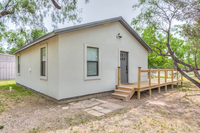 rear view of house featuring a wooden deck