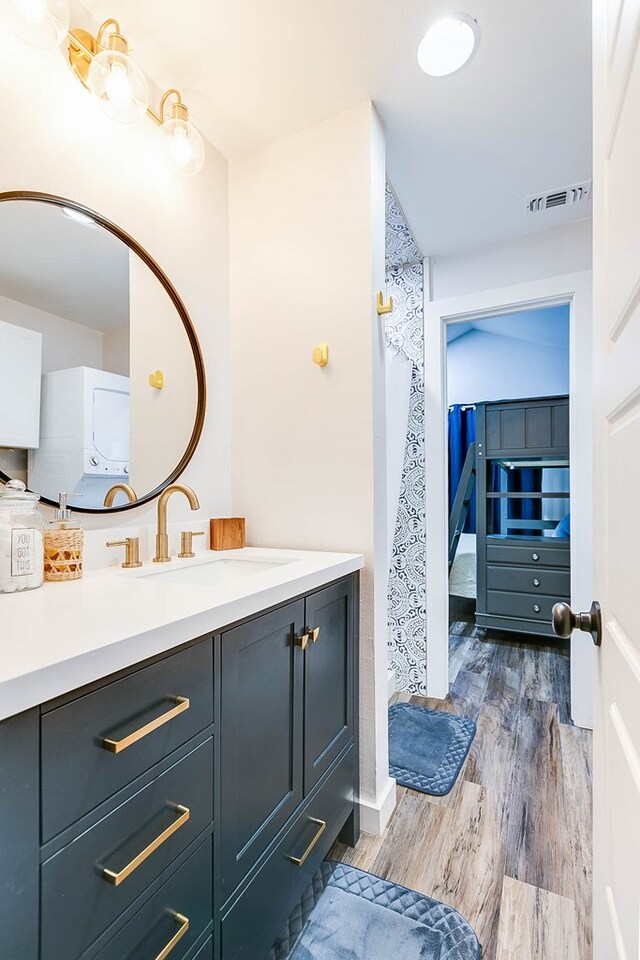 bathroom featuring vanity, washer / dryer, and hardwood / wood-style floors