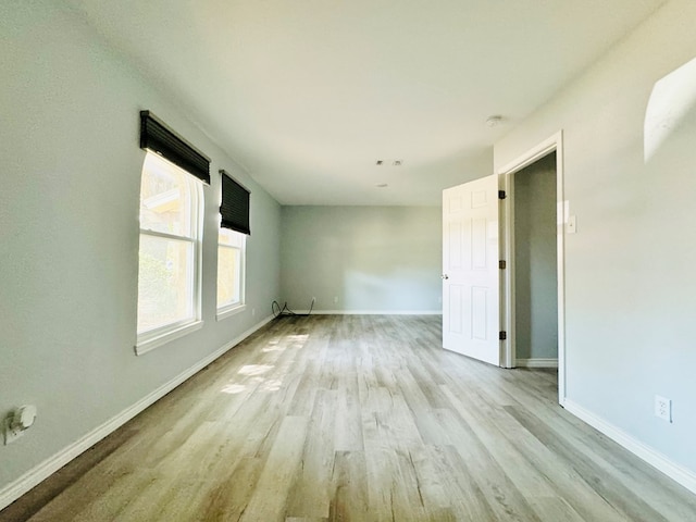 unfurnished room with light hardwood / wood-style floors