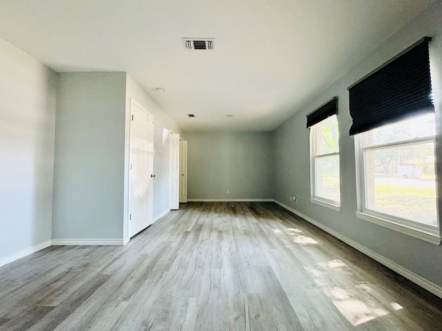 spare room with light hardwood / wood-style floors