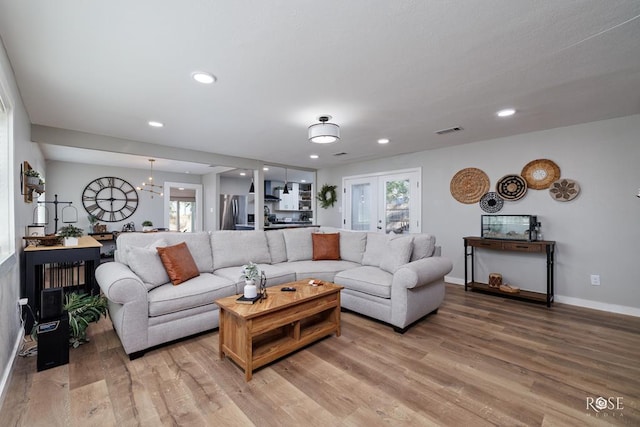 living room featuring hardwood / wood-style floors and a notable chandelier