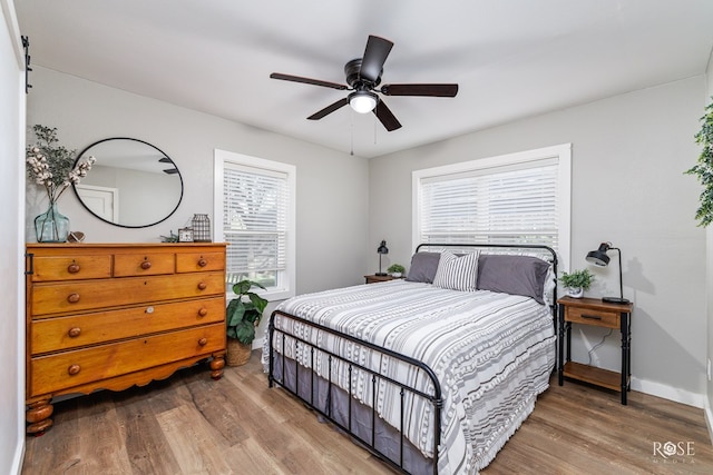 bedroom with hardwood / wood-style flooring and ceiling fan