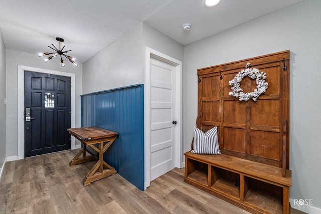 entrance foyer with an inviting chandelier and hardwood / wood-style floors