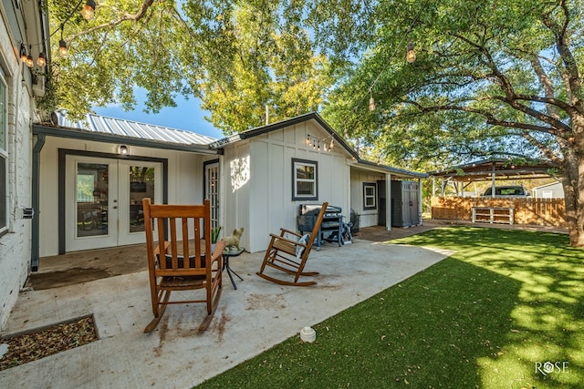 back of property featuring a patio, a yard, and french doors