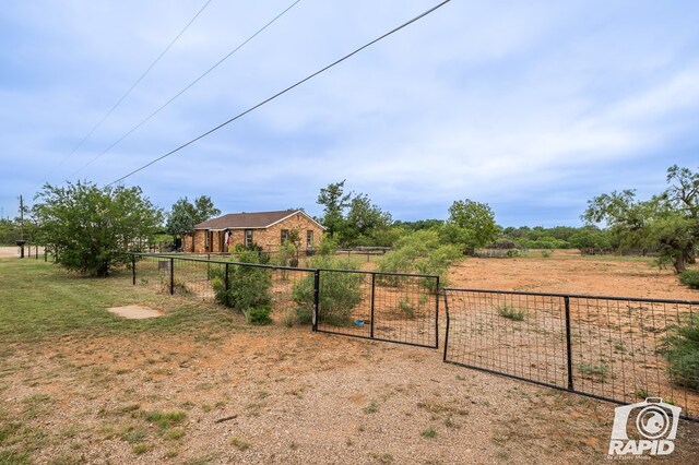 view of yard with a rural view