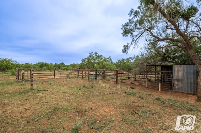 view of yard featuring a rural view and an outbuilding