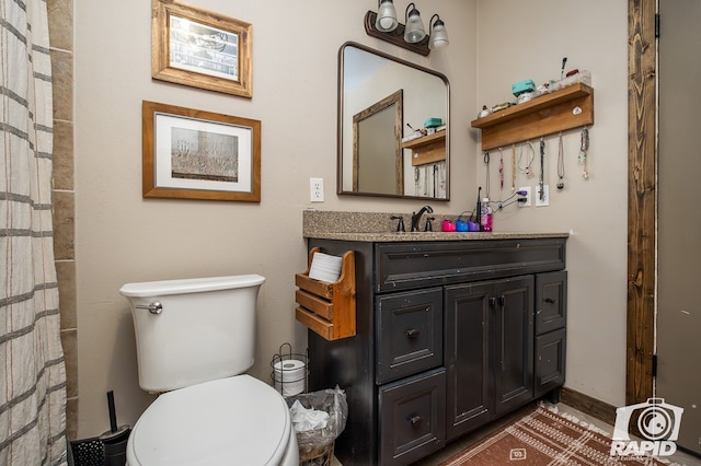 bathroom featuring vanity and toilet