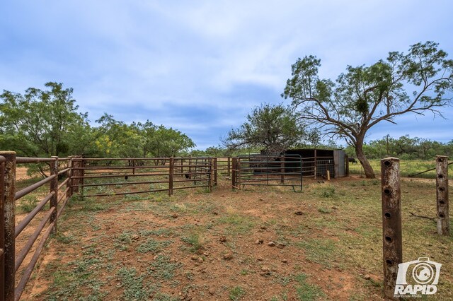 view of yard with an outbuilding and a rural view