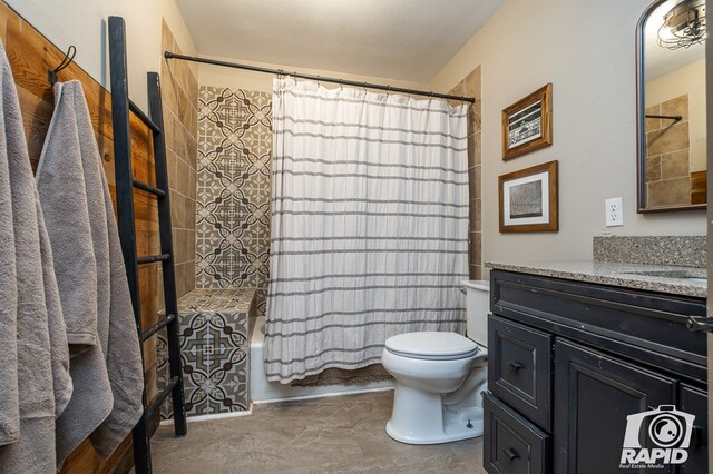 full bathroom with vanity, toilet, and shower / bath combo with shower curtain