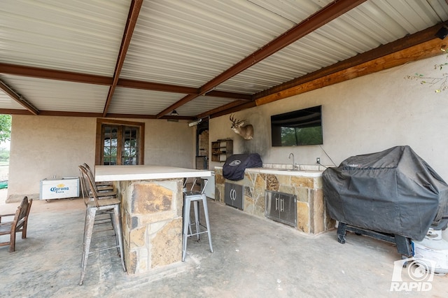 view of patio / terrace featuring a grill and an outdoor bar