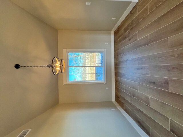 spare room featuring wood walls