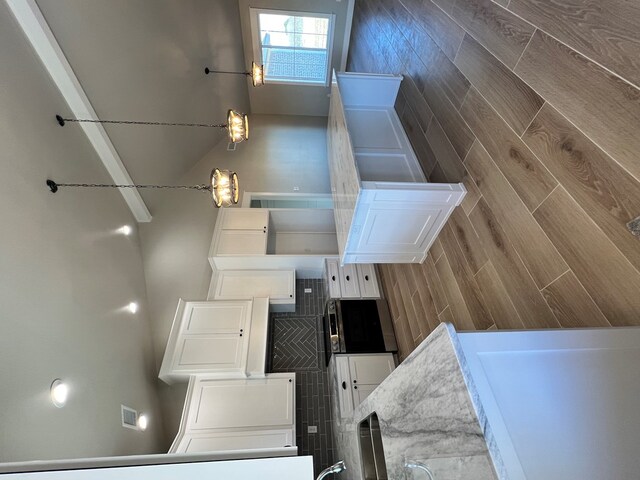 kitchen with white cabinetry and decorative light fixtures