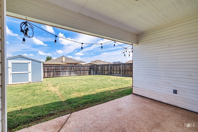 view of yard with a shed and a patio area