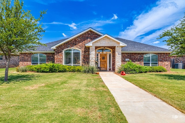 ranch-style home featuring central AC and a front yard