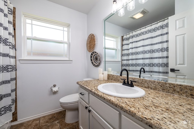 bathroom featuring vanity and toilet