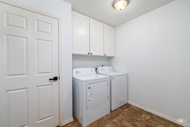 laundry room featuring cabinets and separate washer and dryer