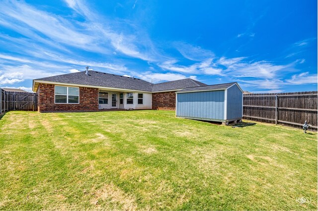 back of property with a shed and a lawn