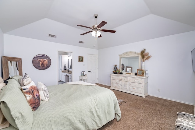 carpeted bedroom with a raised ceiling, lofted ceiling, connected bathroom, and ceiling fan