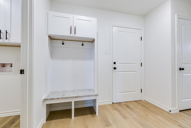 mudroom with light wood-style flooring and baseboards