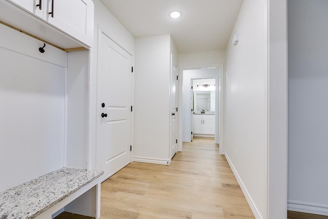 mudroom with recessed lighting, baseboards, and light wood finished floors