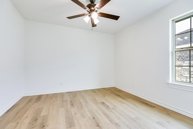 unfurnished room with a healthy amount of sunlight, light wood-type flooring, and baseboards