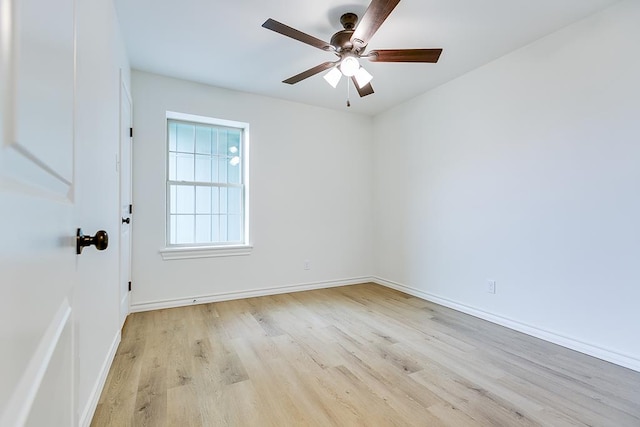 unfurnished room featuring a ceiling fan, light wood-type flooring, and baseboards