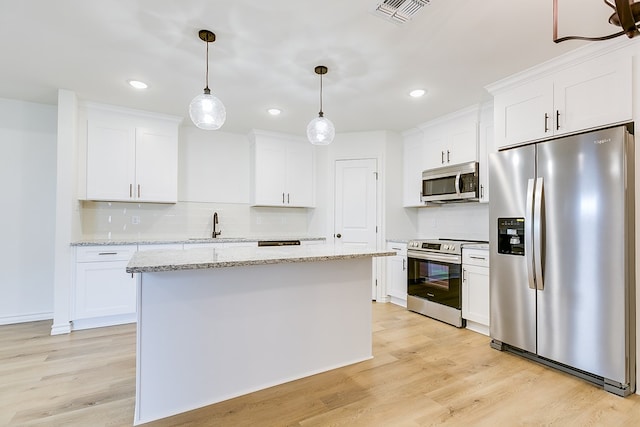 kitchen with visible vents, light wood-style floors, appliances with stainless steel finishes, and white cabinets