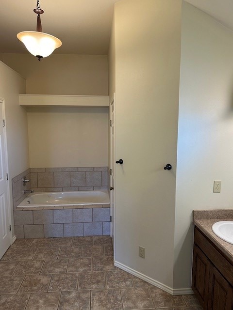 bathroom with a relaxing tiled tub and vanity