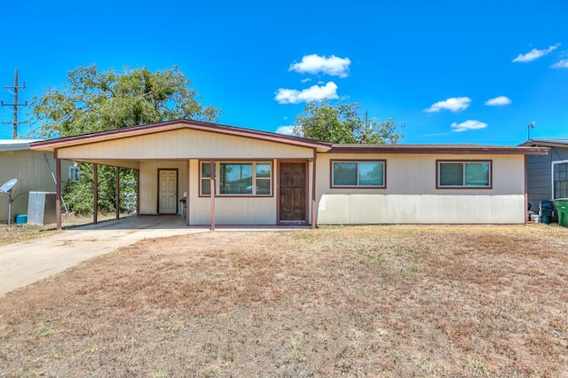 ranch-style home featuring a carport