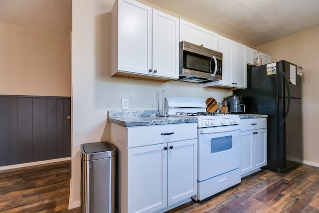 kitchen with dark hardwood / wood-style floors, white cabinets, a textured ceiling, and white gas range oven