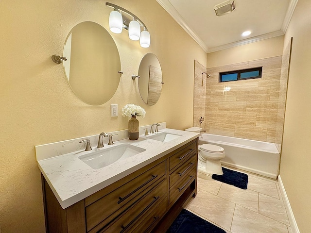 full bathroom with tiled shower / bath, vanity, toilet, crown molding, and tile patterned floors