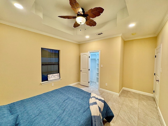 bedroom with crown molding, light tile patterned floors, ceiling fan, and a tray ceiling