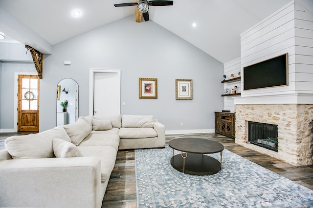 2118 Valleyview Dr, San Angelo, TX 76904 - living room featuring high vaulted ceiling, a ceiling fan, dark wood finished floors, a fireplace, and arched walkways