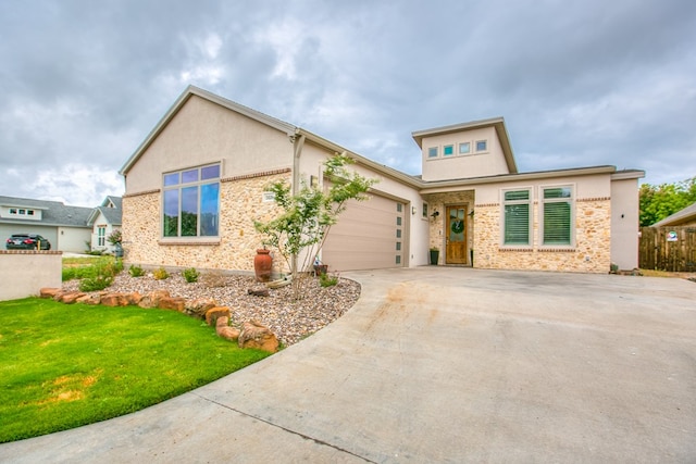 2118 Valleyview Dr, San Angelo, TX 76904 - view of front of house with concrete driveway, an attached garage, stucco siding, and a front yard
