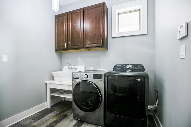 2118 Valleyview Dr, San Angelo, TX 76904 - laundry room featuring washer and clothes dryer, cabinet space, and dark wood-type flooring