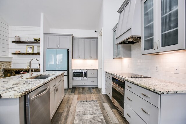 2118 Valleyview Dr, San Angelo, TX 76904 - kitchen featuring stainless steel appliances, premium range hood, gray cabinets, dark wood-type flooring, and light stone countertops