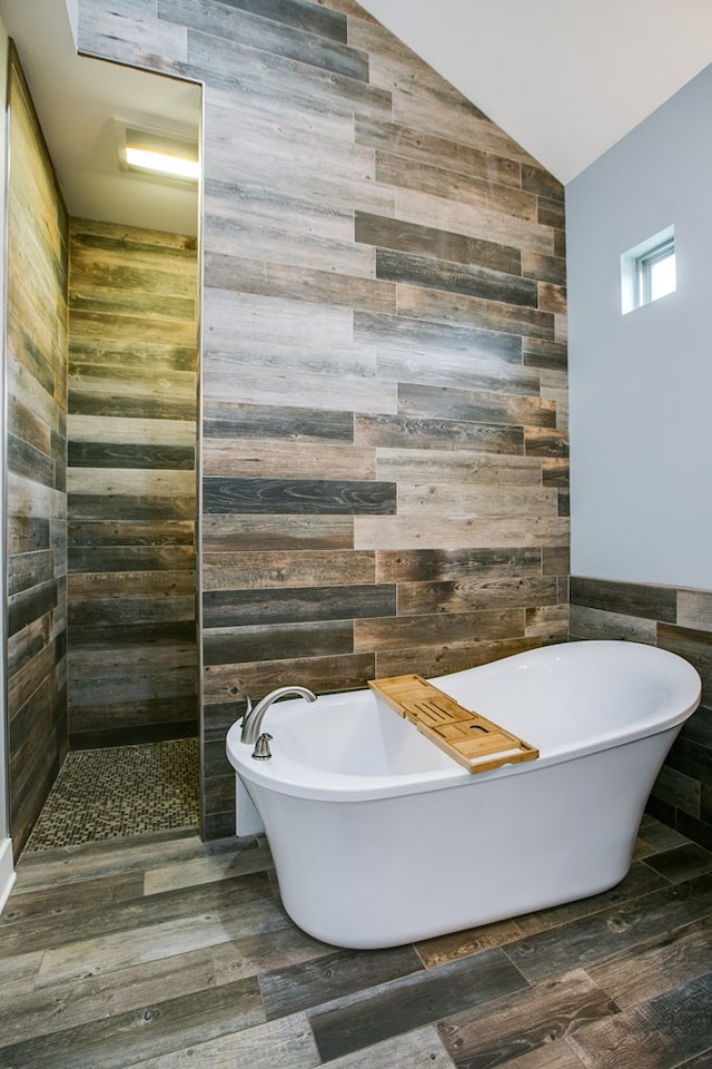 2118 Valleyview Dr, San Angelo, TX 76904 - bathroom with tile walls, a freestanding bath, wood finished floors, and lofted ceiling