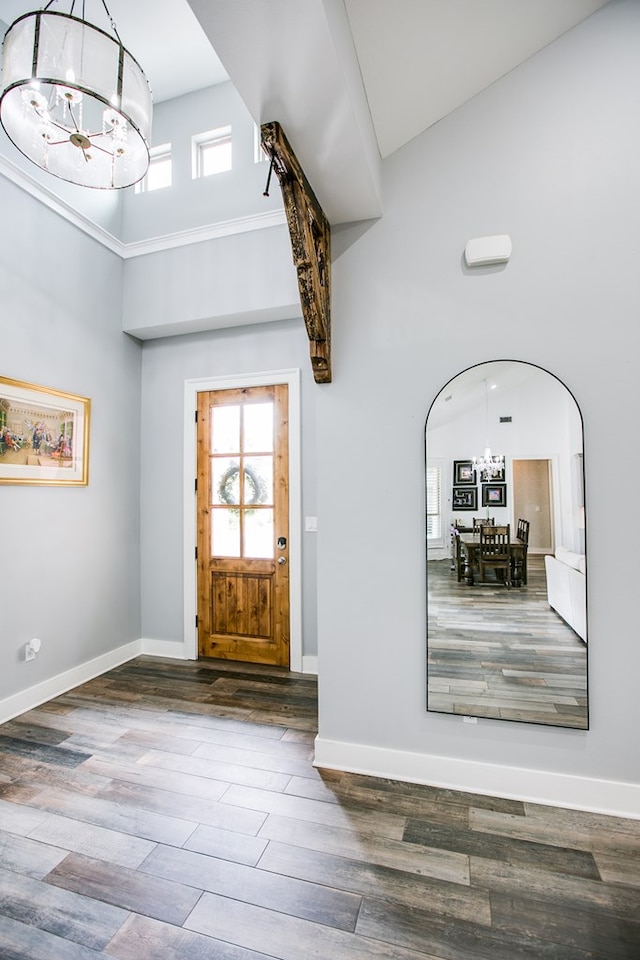 2118 Valleyview Dr, San Angelo, TX 76904 - entrance foyer with a chandelier, a high ceiling, healthy amount of natural light, wood finished floors, and arched walkways