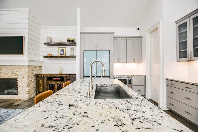 2118 Valleyview Dr, San Angelo, TX 76904 - kitchen featuring built in refrigerator, gray cabinetry, dark wood-style floors, and light stone countertops